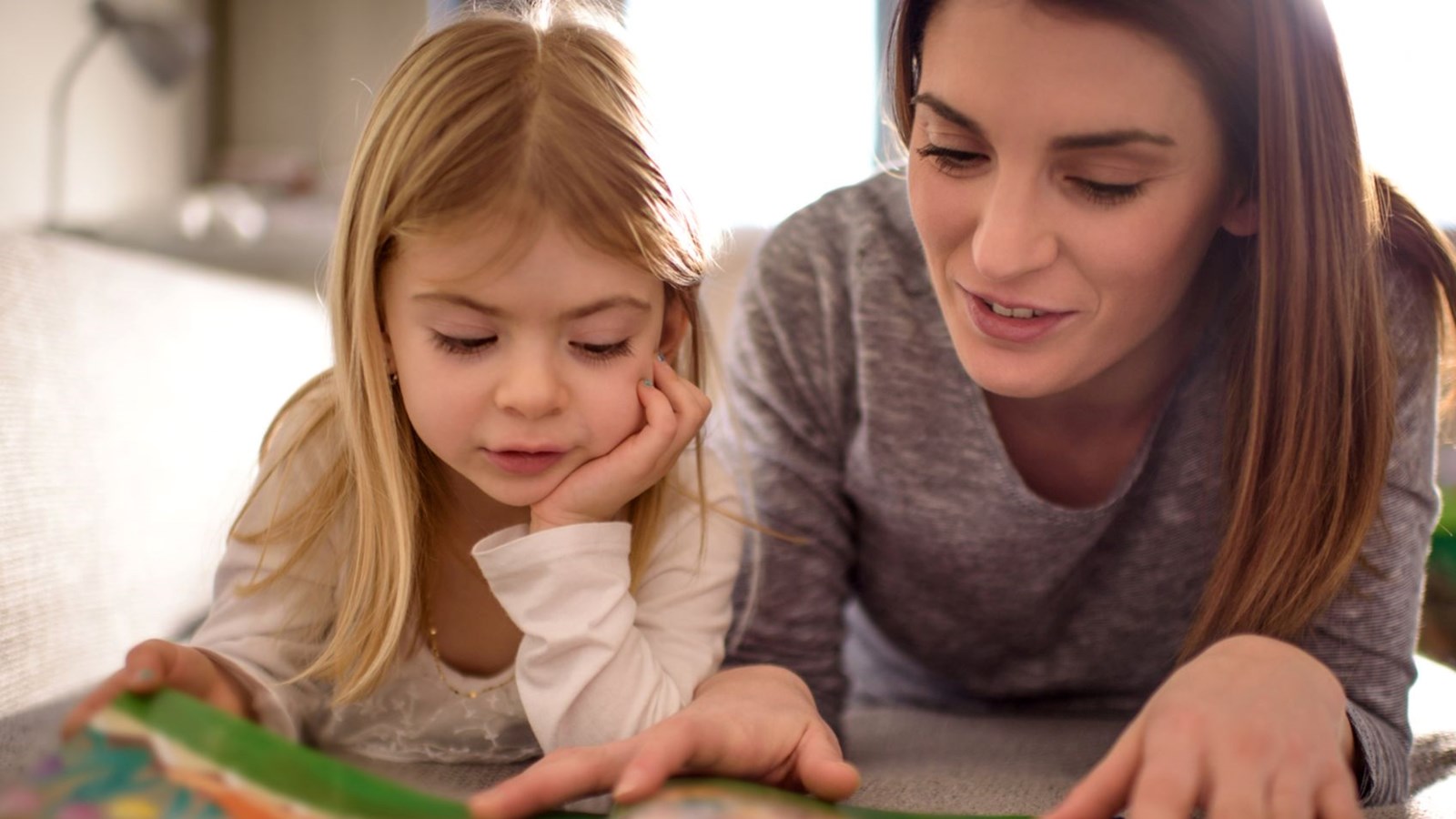 mom reading with little girl